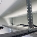 Linear garage door opener rail with additional support